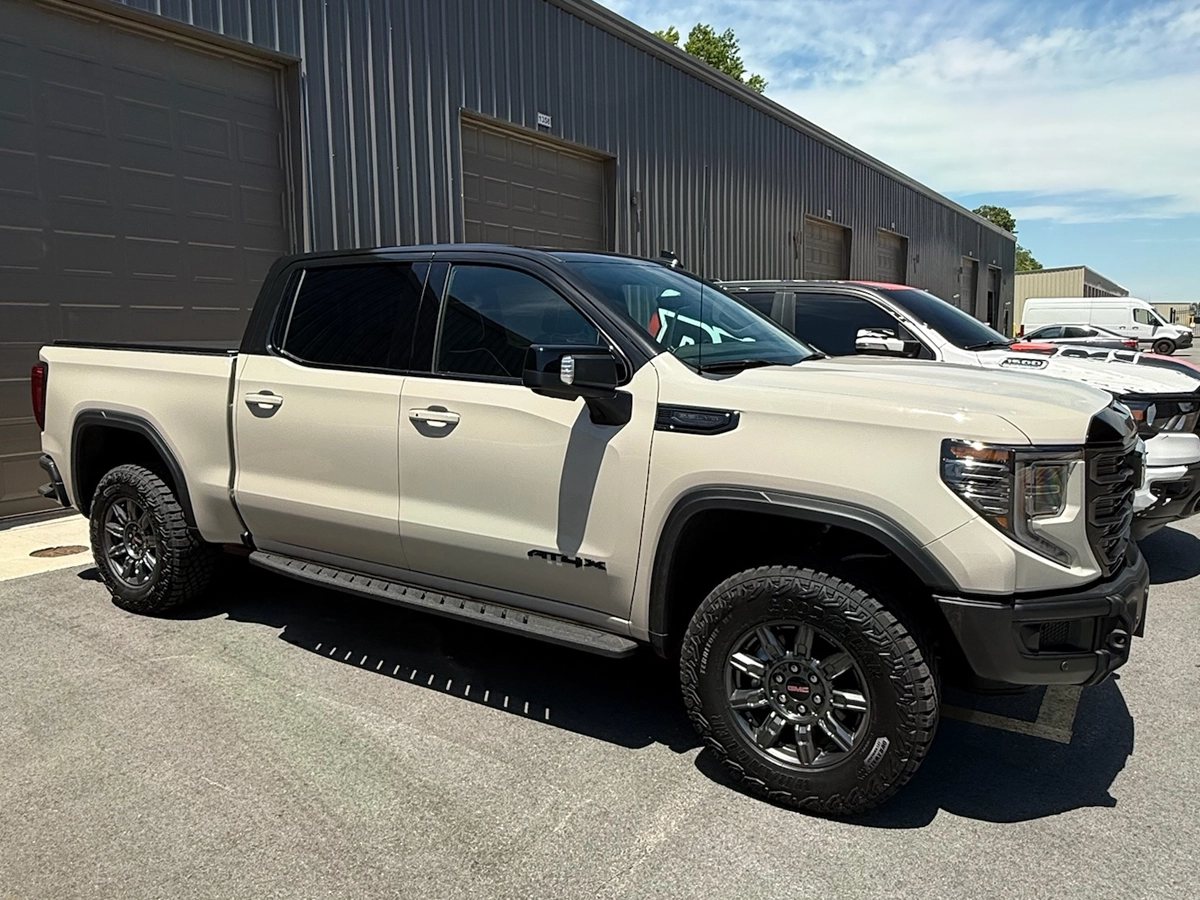 Desert tan Sierra Truck with gloss black tuxedo wrap.