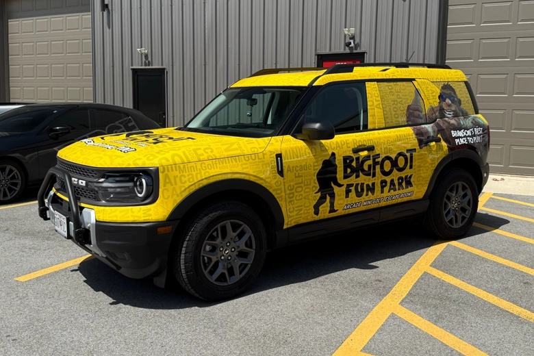 Ford Bronco Sport with bright yellow full wrap branding.