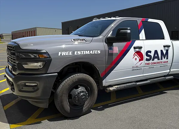 Partial vehicle wrap in grey and red tone with company logos on doors.