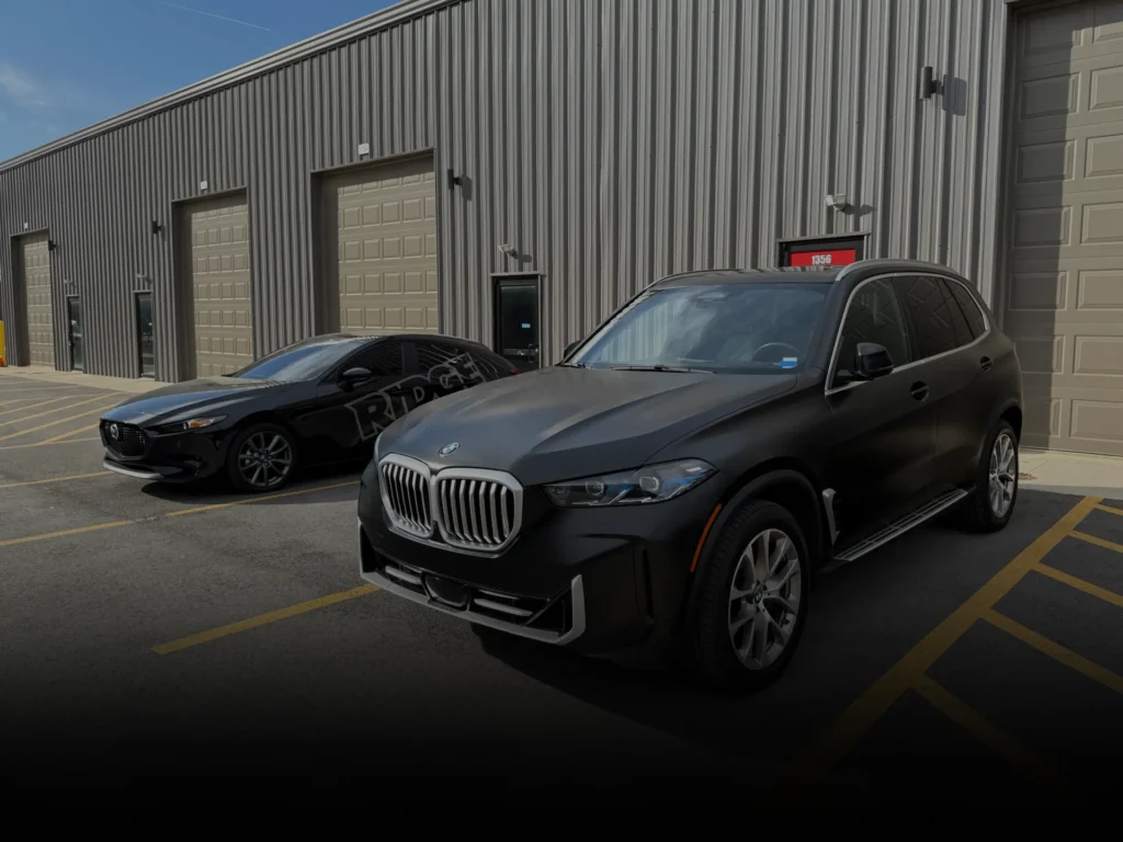Professionally vinyl wrapped satin black SUV.