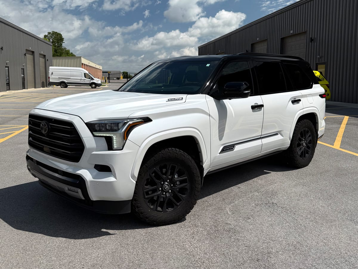 gloss black tuxedo wrap installed on top of suv.